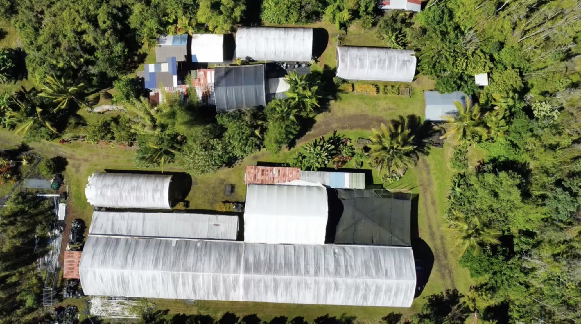 Aerial view of the greenhouses and grounds at 15-1300 Auina St