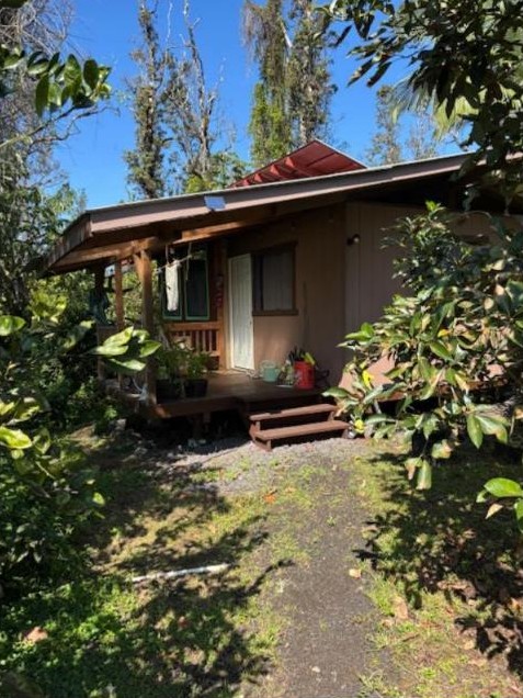 Cabin with a covered porch among the trees